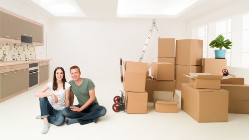 Local movers organising fragile items and labelled boxes in Barnet