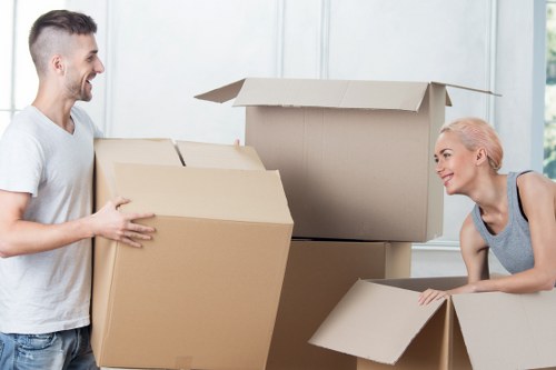 Moving boxes and household belongings prepared for a van removal service