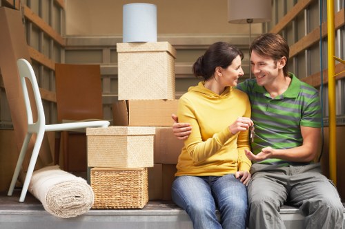 Professional movers carrying furniture from a Barnet home