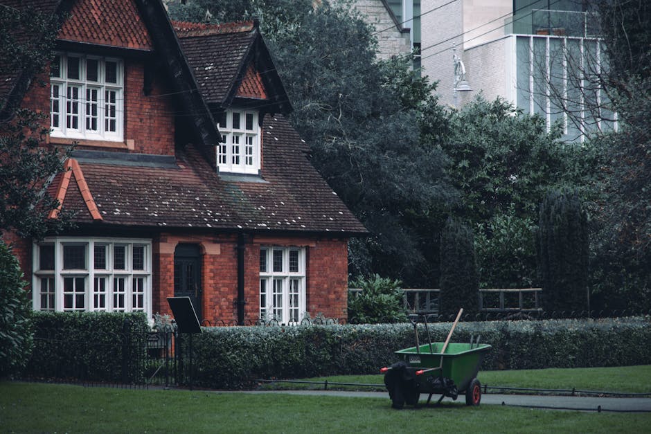 A row of traditional terraced houses with ornate Victorian-style facades, featuring bay windows, decorative ironwork balconies, and gabled roofs, situated on a residential street in Barnet. The houses